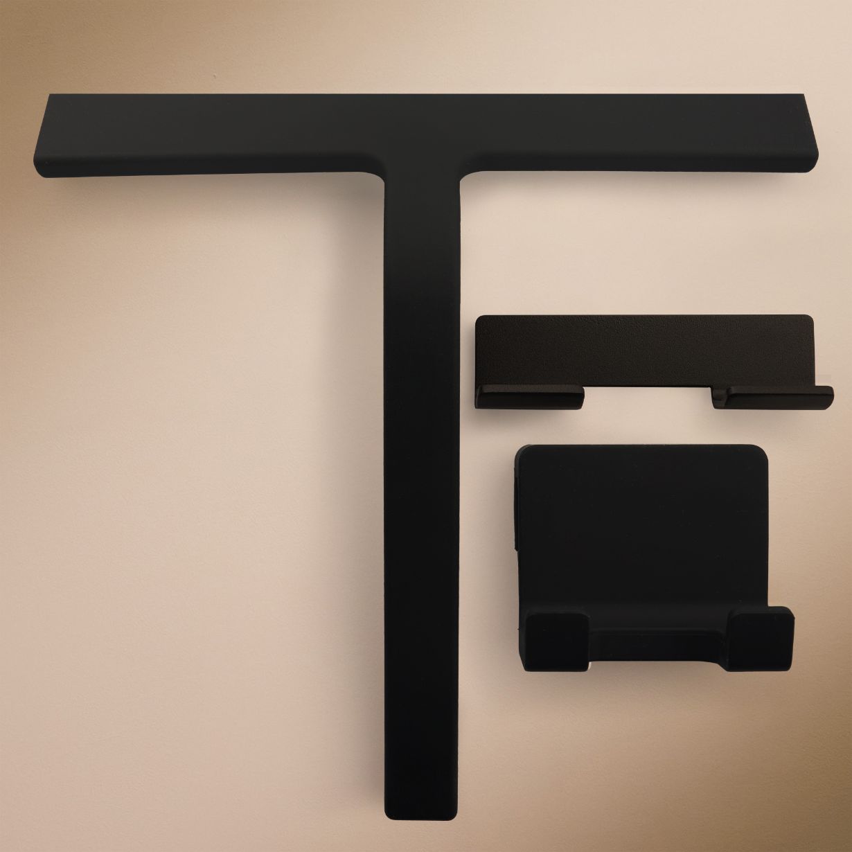 Klebr shower squeegee in matte black — front view with adhesive wall holder and silicone hanger