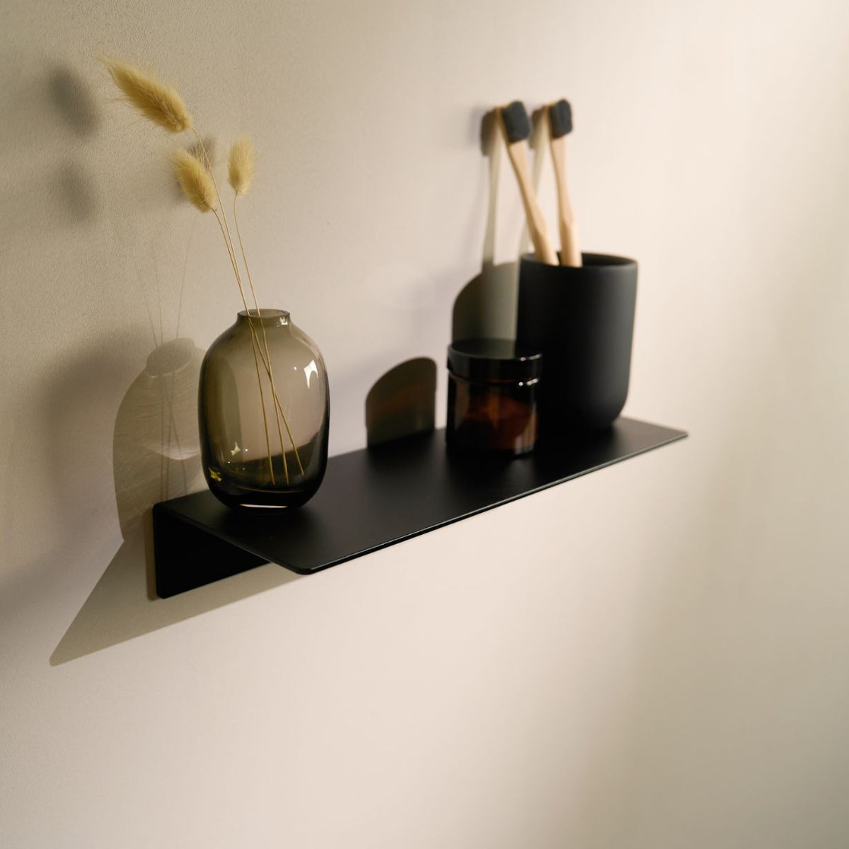 Matte Black adhesive wall shelf 30cm — black, styled with bathroom accessories