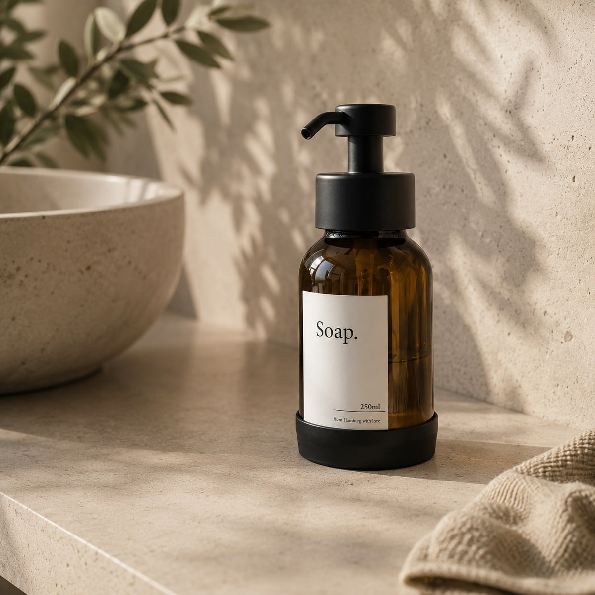 Matte Black freestanding soap dispenser with brown glass, studio shot 2
